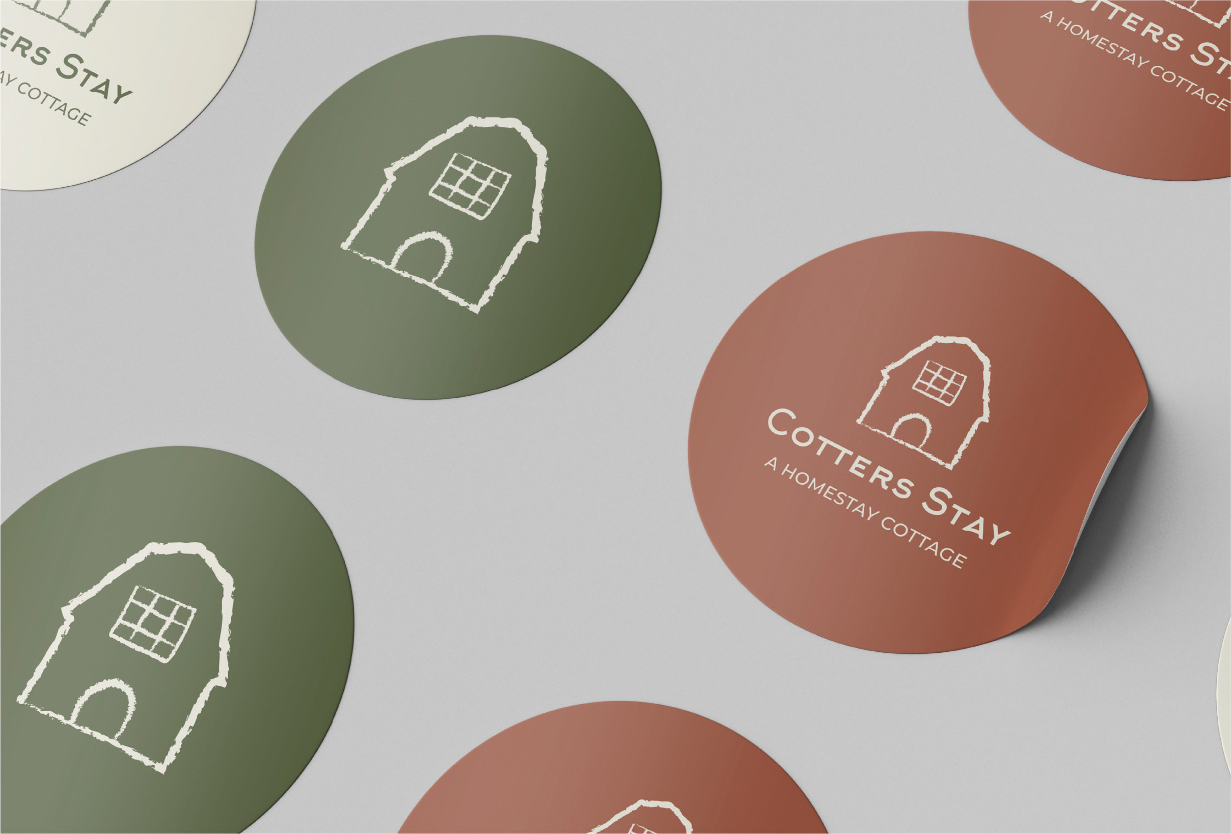 Image of green and brown circular stickers with Cotters stay logo in the center