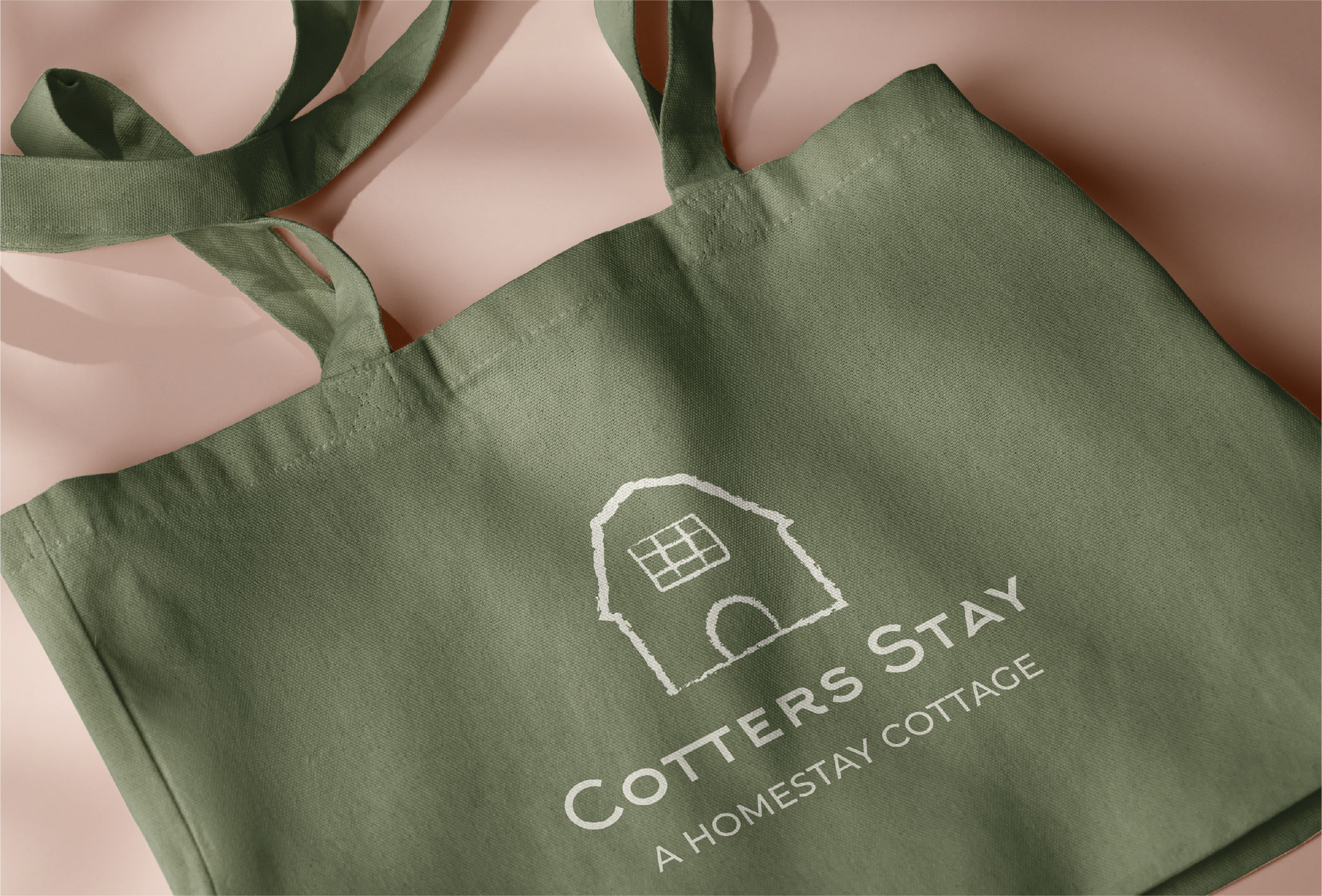 Image of green tote bag with Cotters stay logo at center