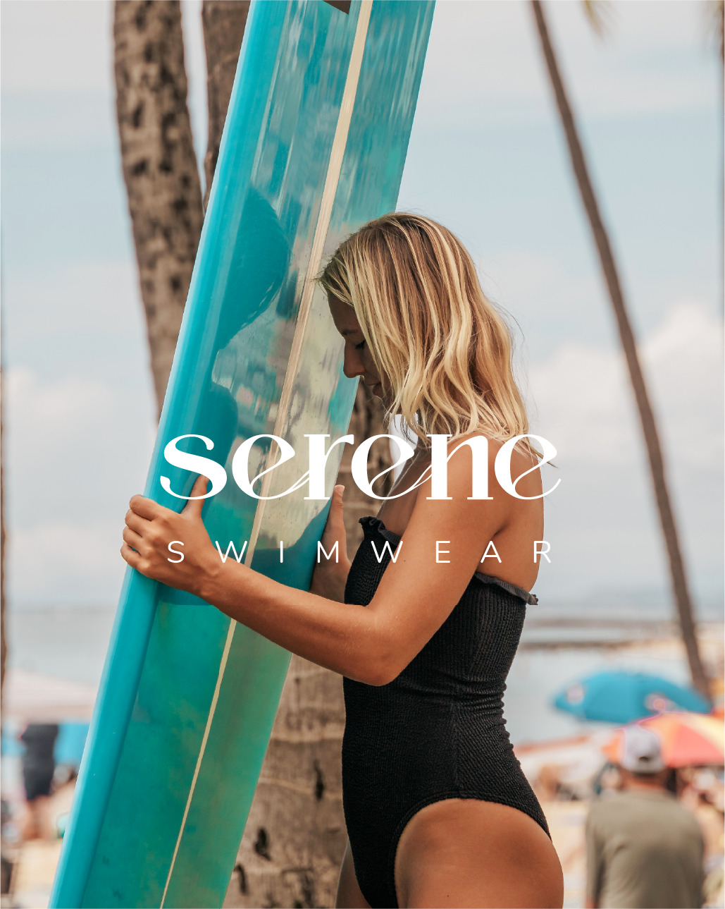 picture of a blonde woman holding a blue surfboard